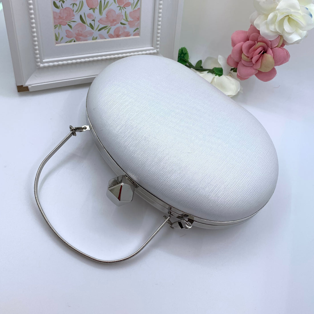 White Oval Clutch With Silver Frame